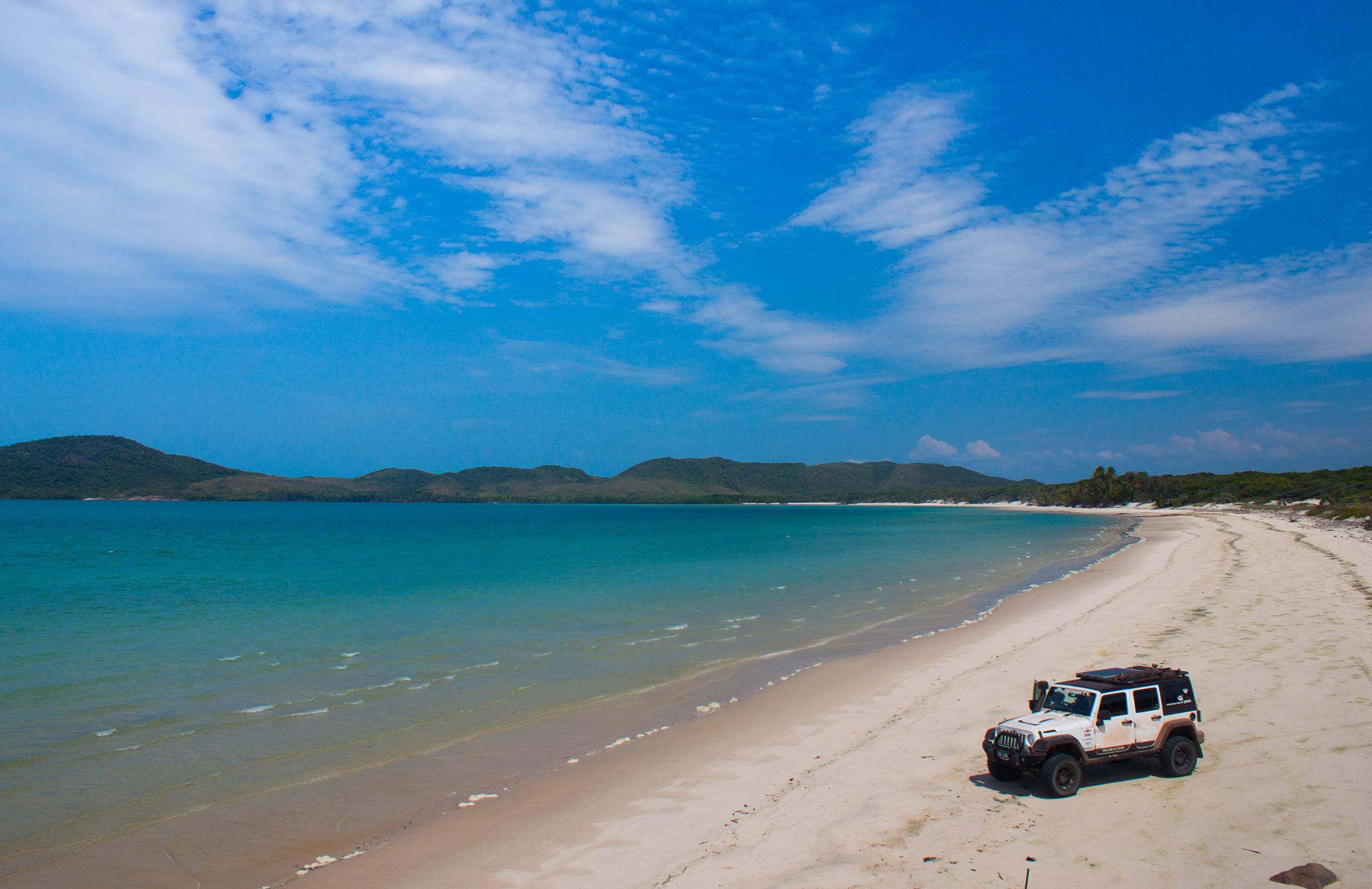 Clear skys and clear water and beach driving