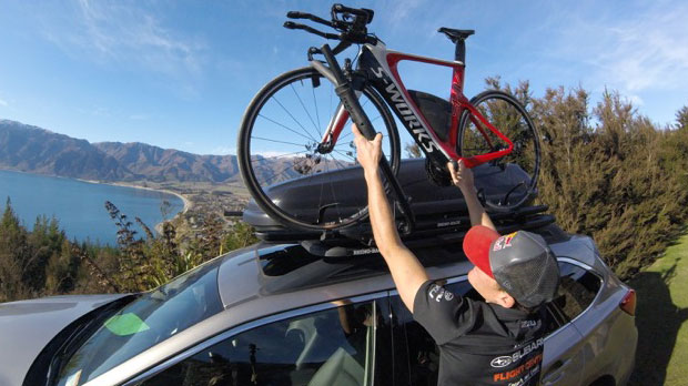 Triathlete Braden Currie putting his bike in the Rhino-Rack bike rack on his Subaru