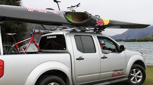 Triathlete Braden Currie driving to train with Rhino-Rack Kayak and bike carriers