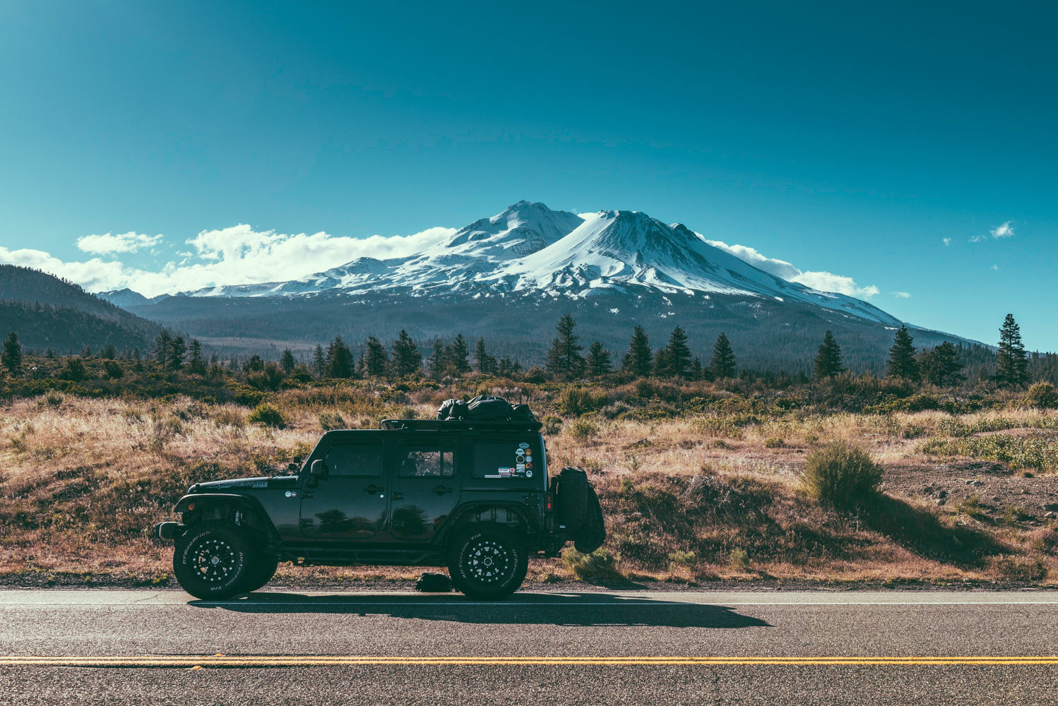 Jeep with snowy mountain backdrop