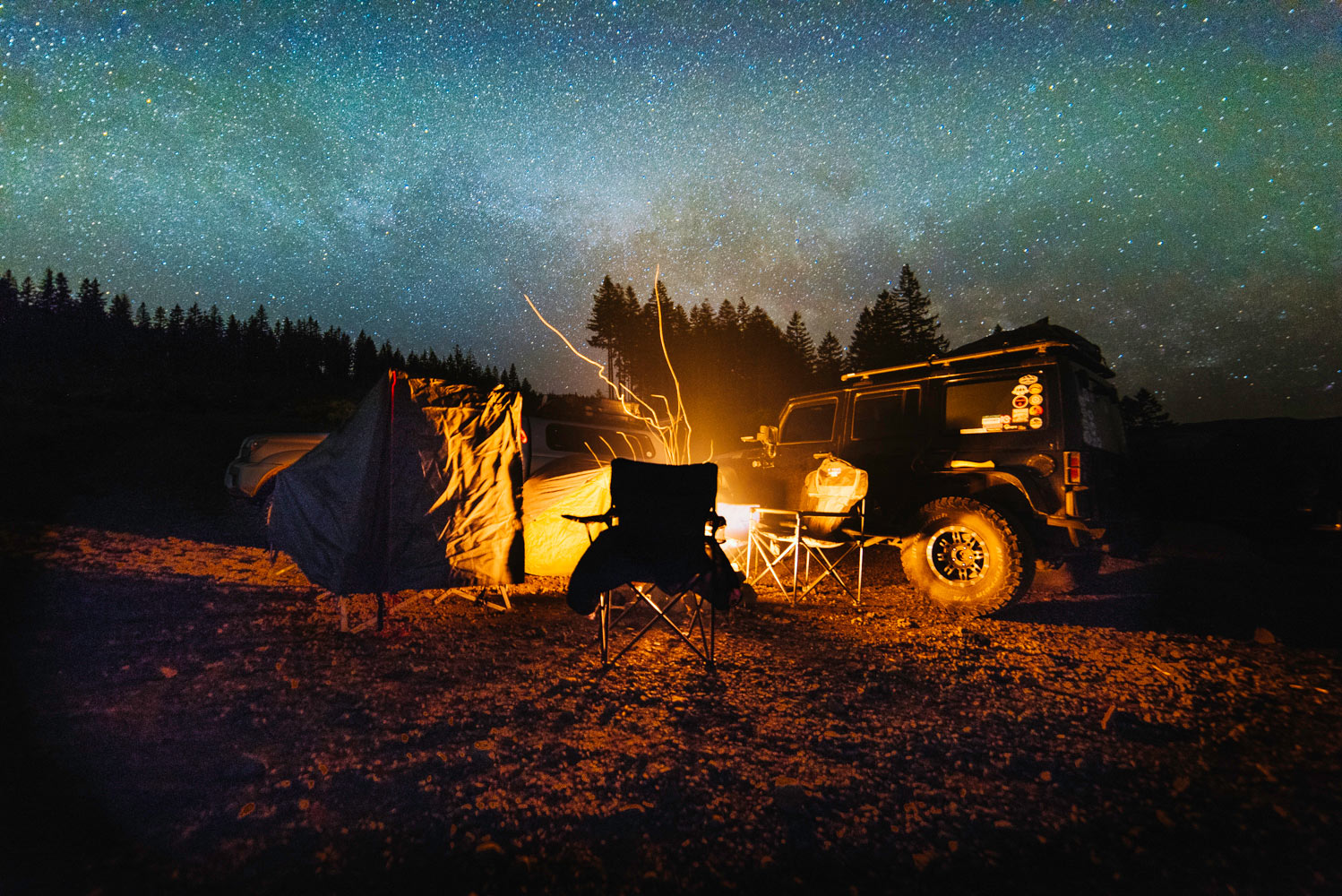 Campsite with a fire under the blanket of stars