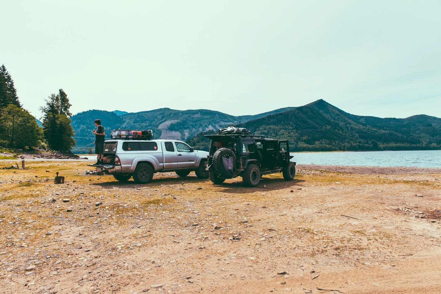 Jeep and Toyota by the water with mountain views