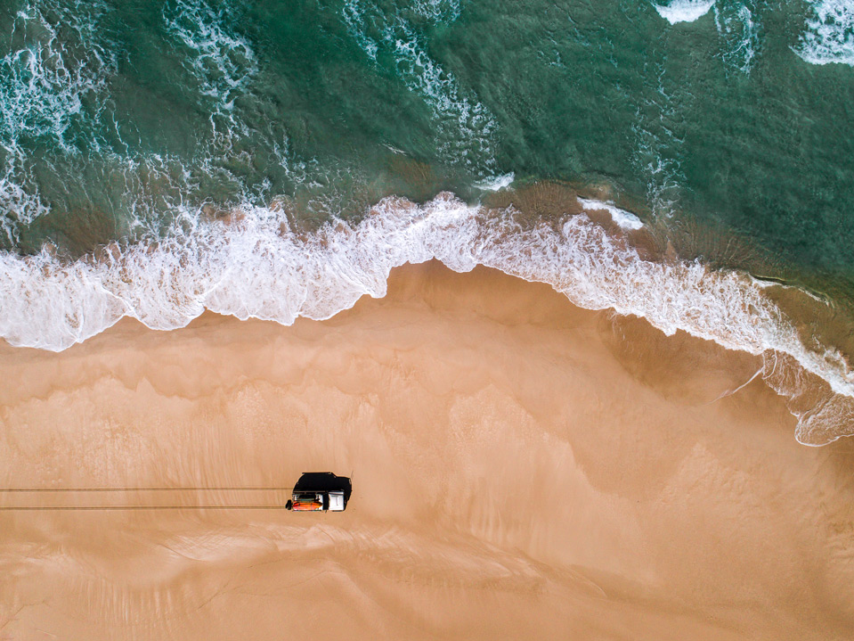 Blacksmiths Beach drone photography: Driving by the water 